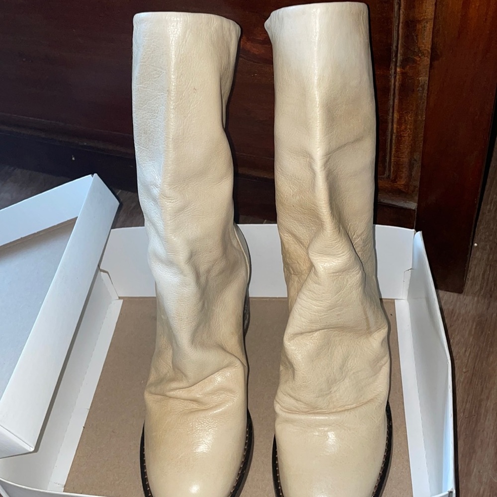 NWT slouchy leather boot featuring distressed details and a high stacked heel.